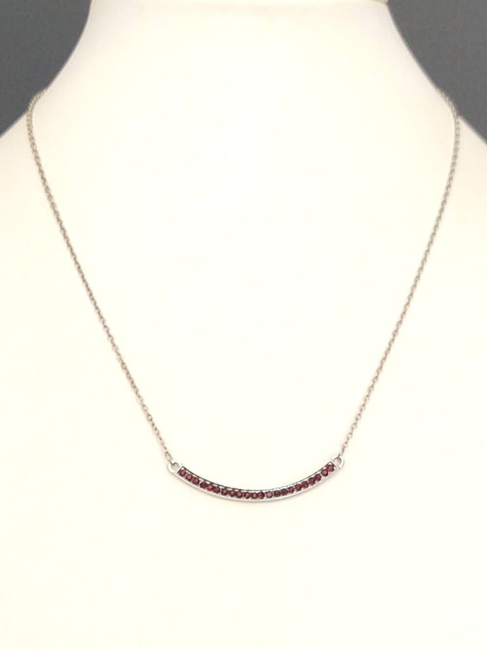 Curved bar necklace with reddish purple tiny stones
